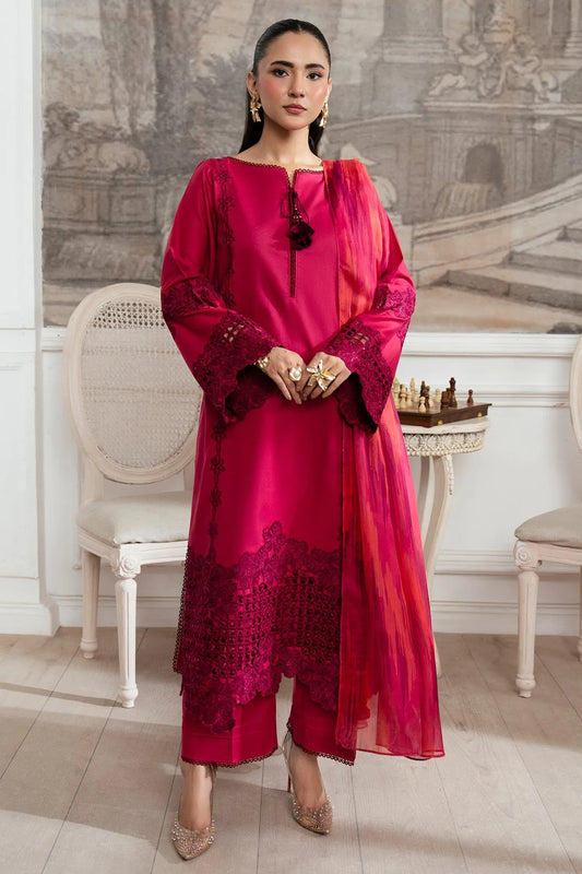 Woman in a red traditional outfit standing in an elegant room with classical decor.
