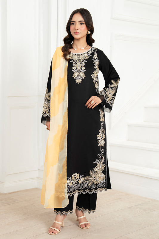 Woman wearing a black embroidered outfit with a yellow dupatta against a white background