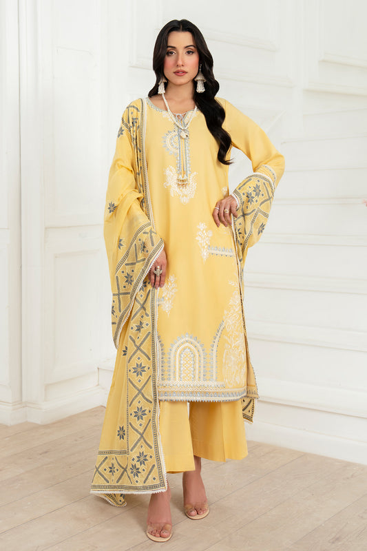Woman wearing a yellow embroidered traditional outfit with a matching dupatta.
