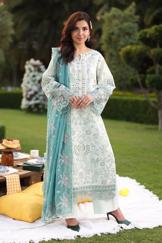 A woman wearing an ice blue lawn suit with embroidery, consisting of a shirt, sleeves with borders, and trousers, paired with a matching chiffon dupatta.