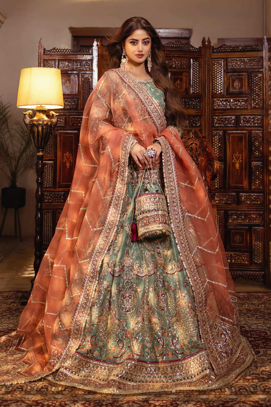 A woman wearing a traditional, embroidered organza lehenga in green and brown with dupatta.