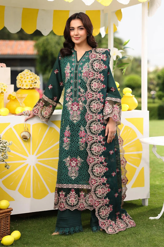 A woman wearing a bottle green lawn suit with embroidered patterns, including a shirt, dupatta, and trousers.