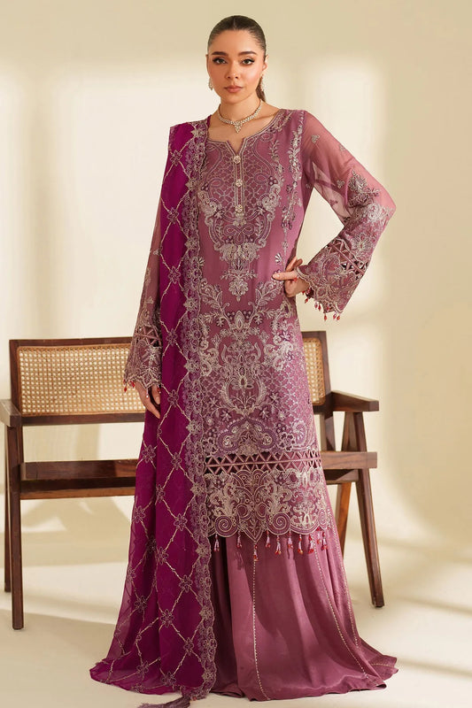 Woman wearing a traditional pink and purple embroidered outfit with a matching dupatta, standing against a neutral background.